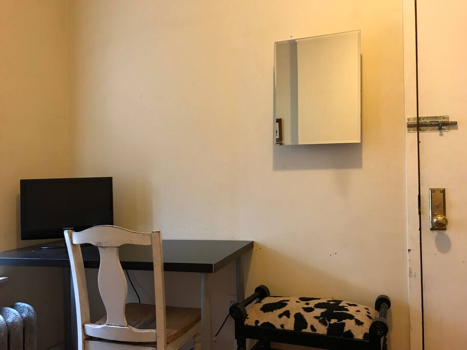 Desk, Apple TV, cabinet with toiletries, sitting bench