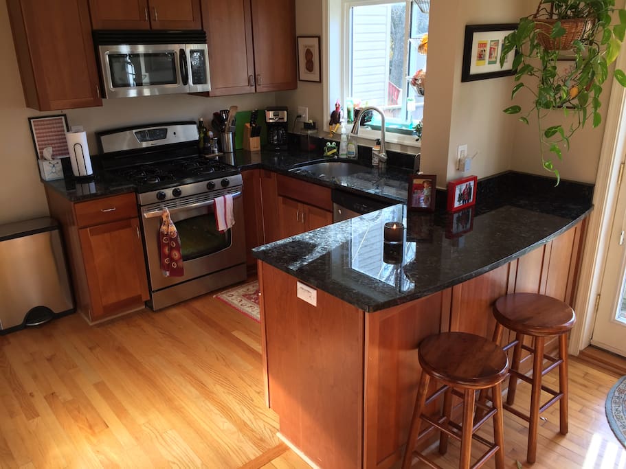 Kitchen with a breakfast nook, gas stove, refrigerator/freezer, dishwasher, and garbage disposal.