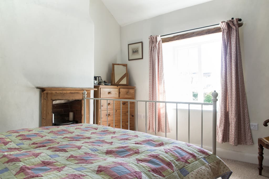 This is our guest room. It is in the old part of the house - one of the original cottage rooms with an open, beamed ceiling and views over the front garden.