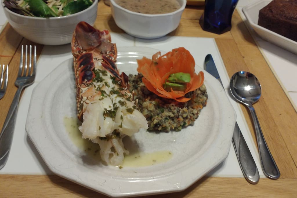 Sample dinner-Baked lobster with garlic parsley lemon butter, rice pilaf with carrot avocado flower, seafood bisque, salad