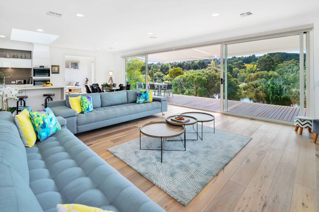 Open plan lounge and dining area, capturing lake views