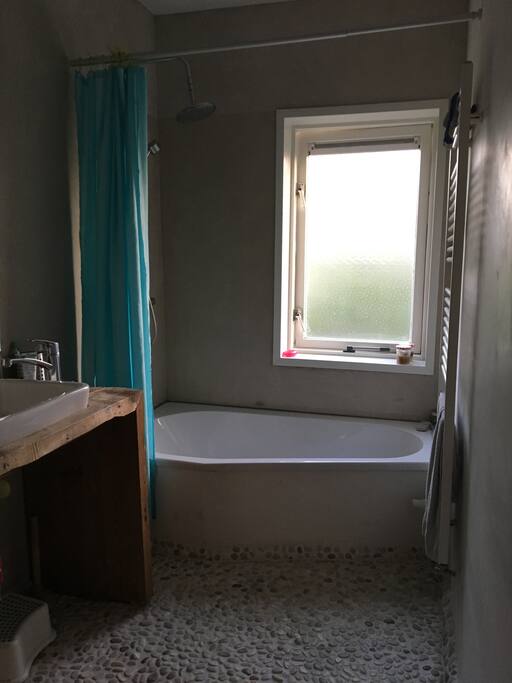 The bathroom with a tub and a sink. There is no toilet in the bathroom