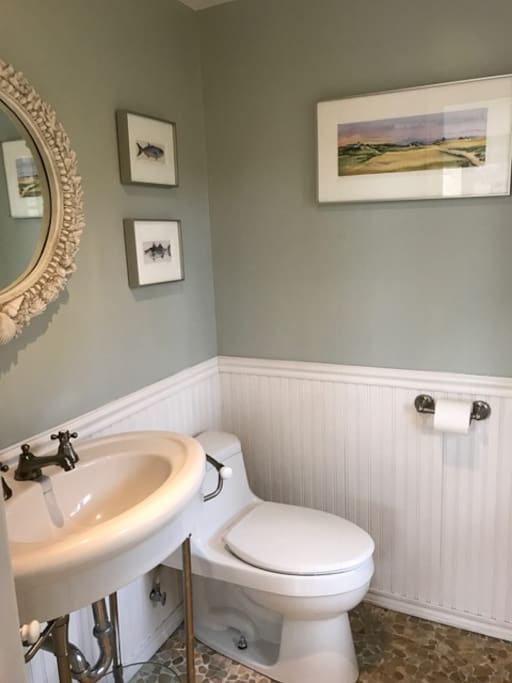 The half bath is located in the open concept living space.