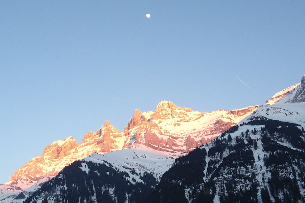 view from the chalet, sunset at wintertime, with moon rising