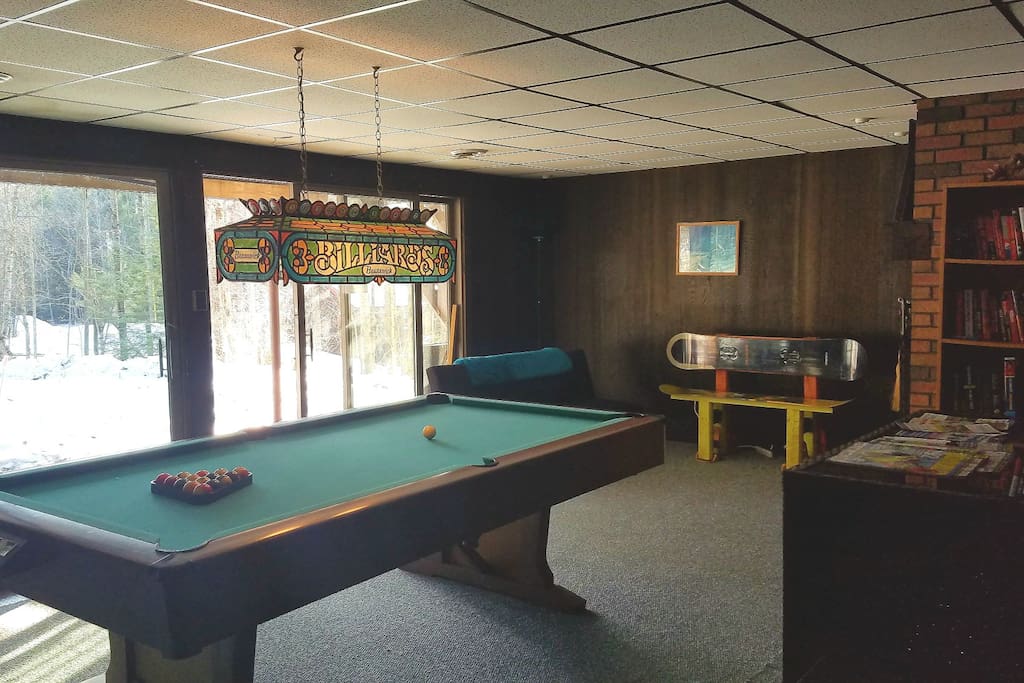 Pool table on first floor, casual seating with TV.