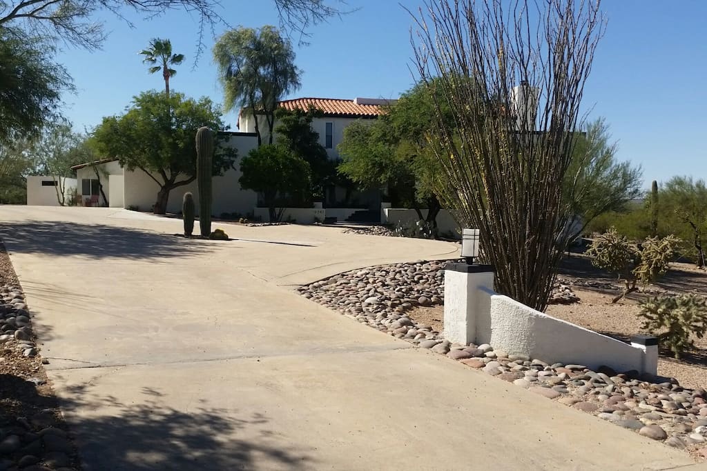 Street view of property. Pool house with private parking on the left side of the main house.