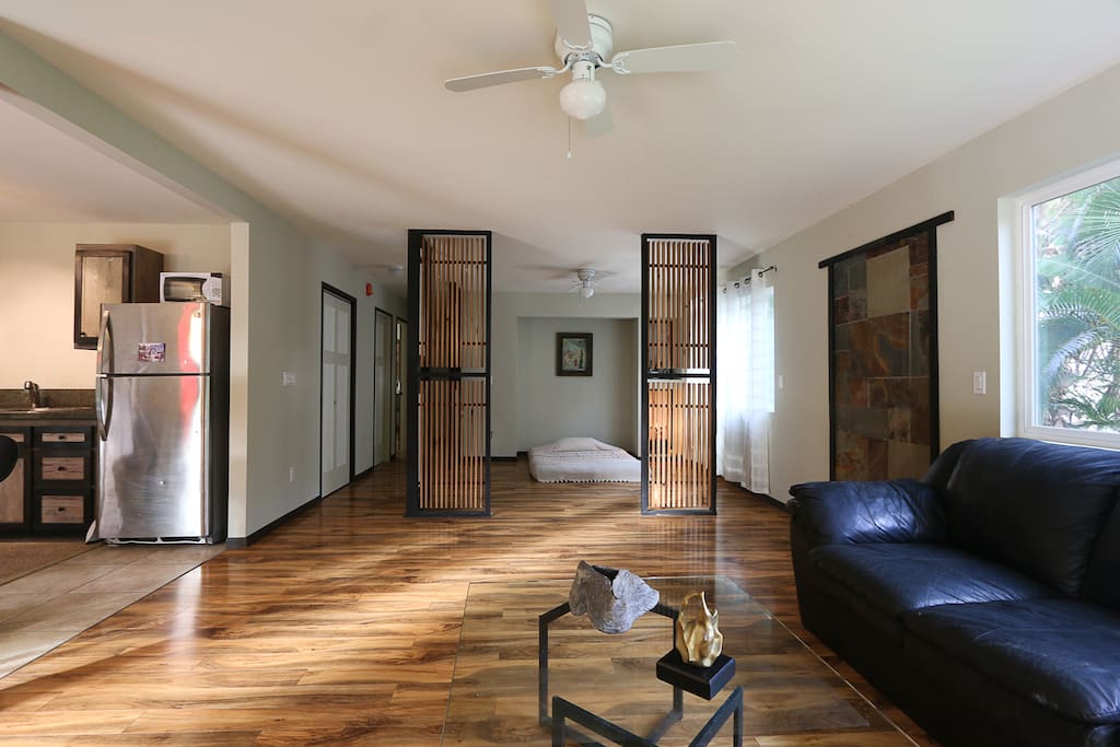 open living room space and den with futon