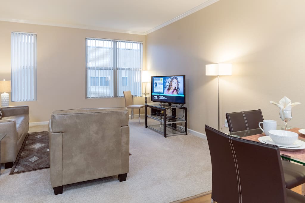 Spacious comfortable living room with pullout sofa bed and club chair