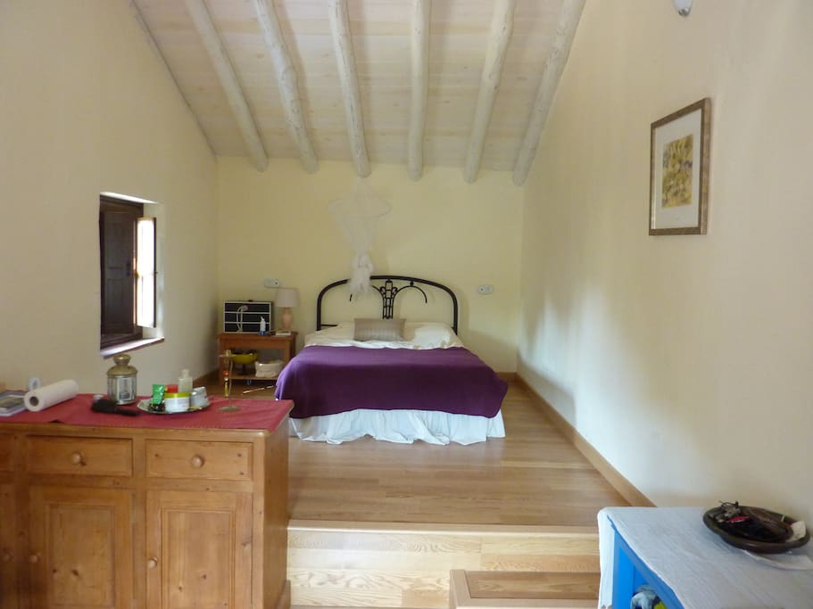 Split level bedroom with direct access to terrace.