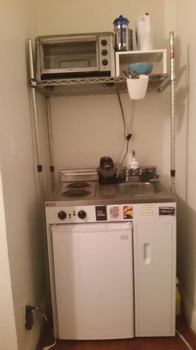Electric stove, mini fridge, toaster oven and filtered water.