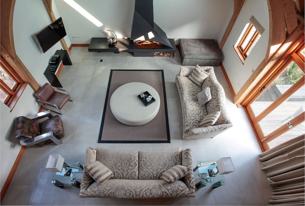 Lounge viewed from gallery with wood burning open fire.