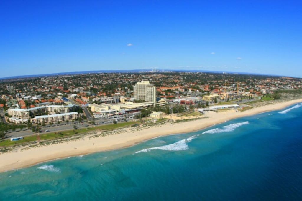 This is a great photo of famous Scarborough beach. Your apartment is located opposite the tallest cream building in photo
