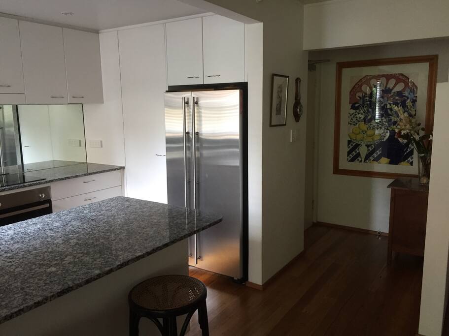 Entryway leading into open plan lounge room and kitchen.
