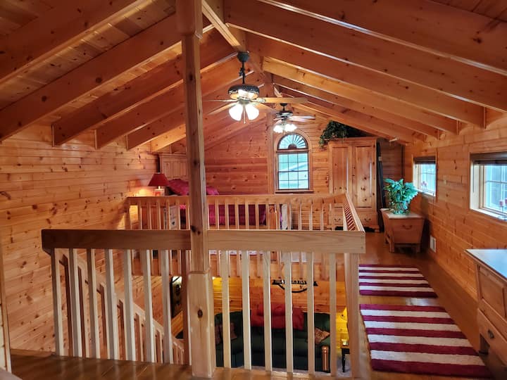 View of the second queen bed and armoire from the first queen bed. 