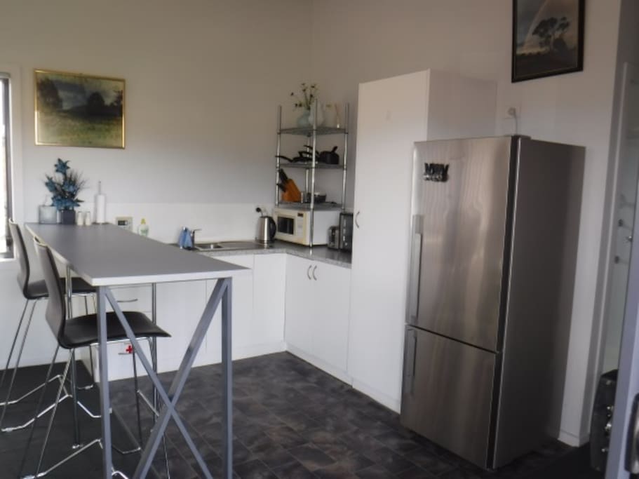 The kitchen is area is equipped with a wide range of cooking appliances.