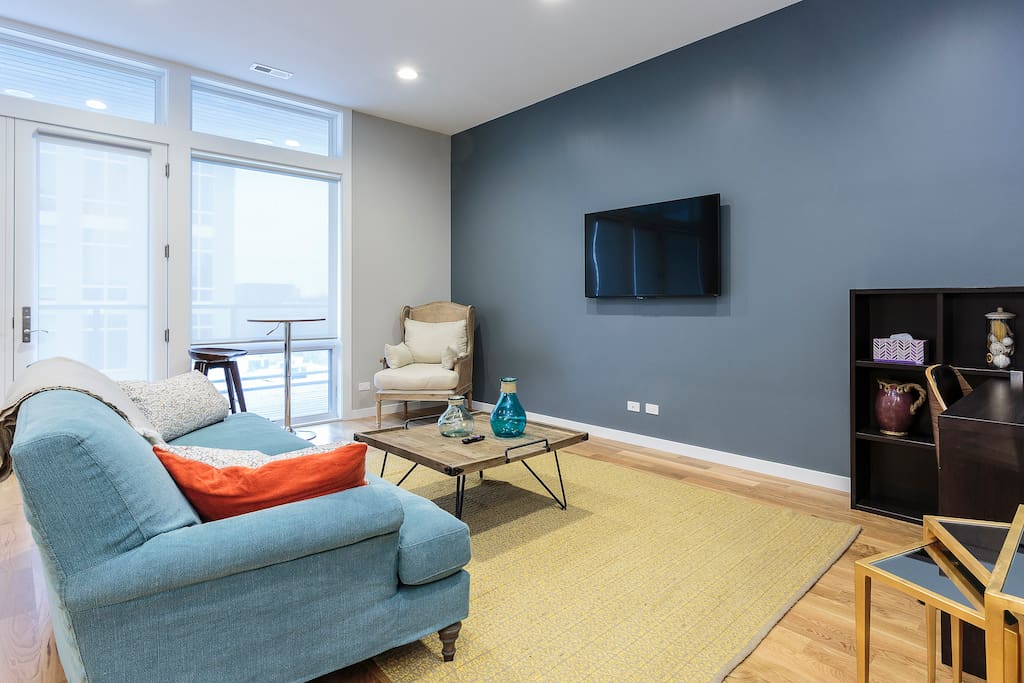 The floor-to-ceiling windows allow light to flood the space
