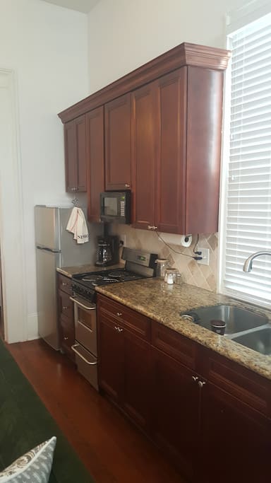 Oven, microwave, stove, double sink w/garbage disposal and refrigerator.