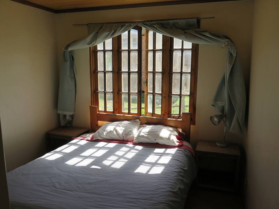 Main bedroom with large window facing north to let light and warmtj in.