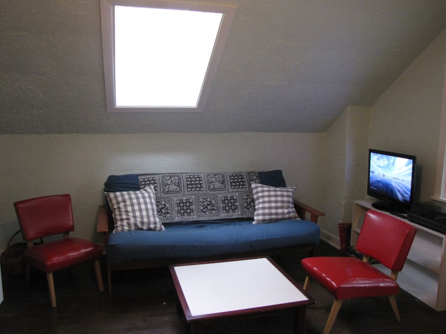 Cozy relaxing area that can be used as a sleeping space for guest three and four on the fold out futon