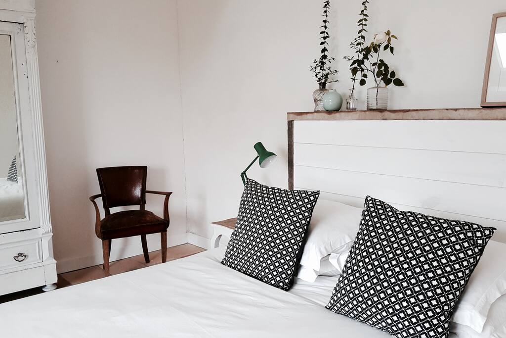 Beautiful main bedroom - with views through French windows to the vines and hills beyond
