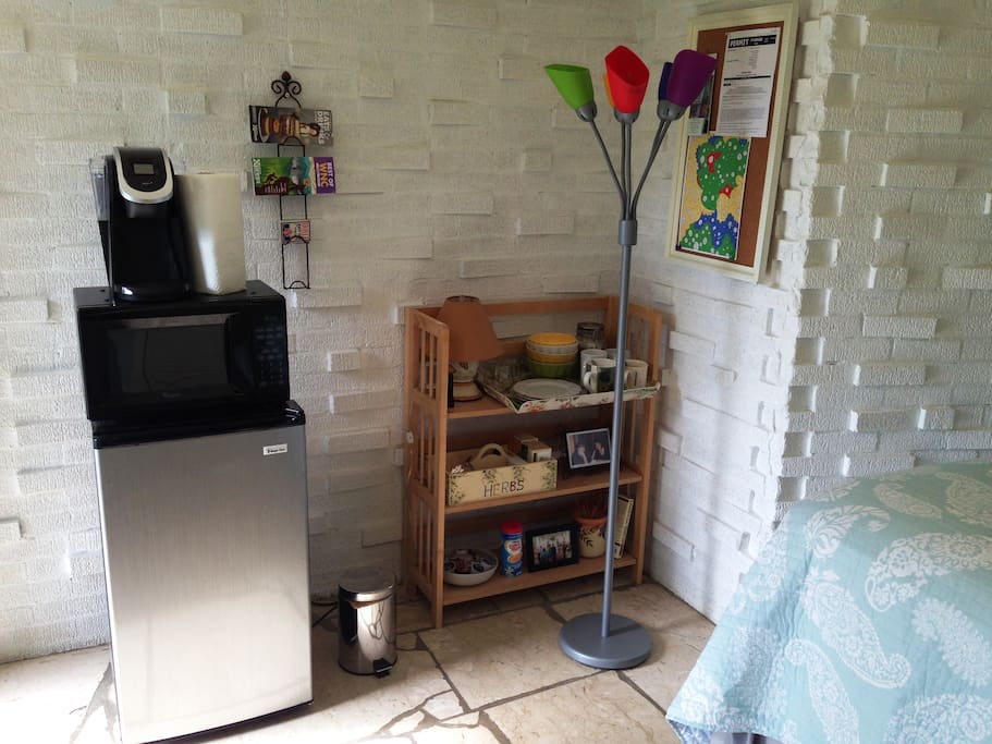 The room has a mini fridge, a microwave, and a Keurig 2.0 coffee maker.