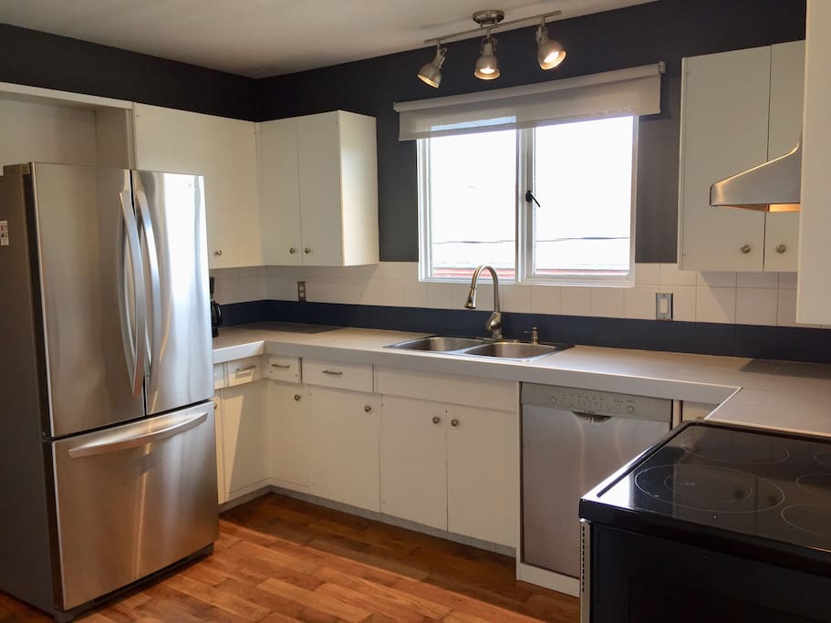 Large kitchen with stainless steel appliances filled with all the amenities you need to stay in and cook