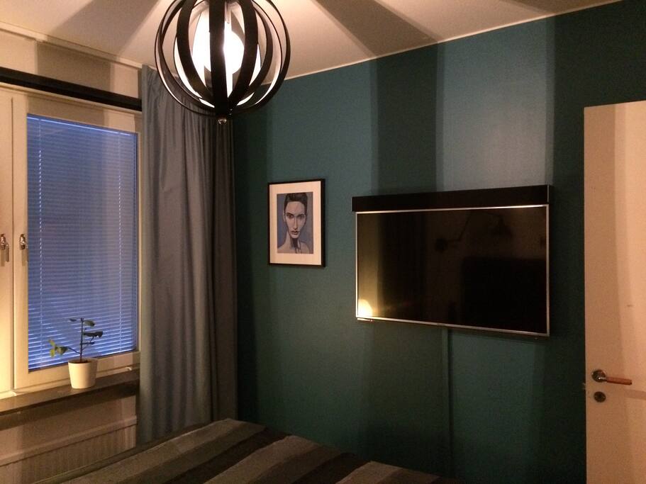 Master bedroom with a flat screen TV.
