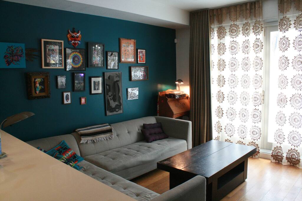 Custom made black out brushed silk curtains floor to ceiling with a sheer for some sunlight.