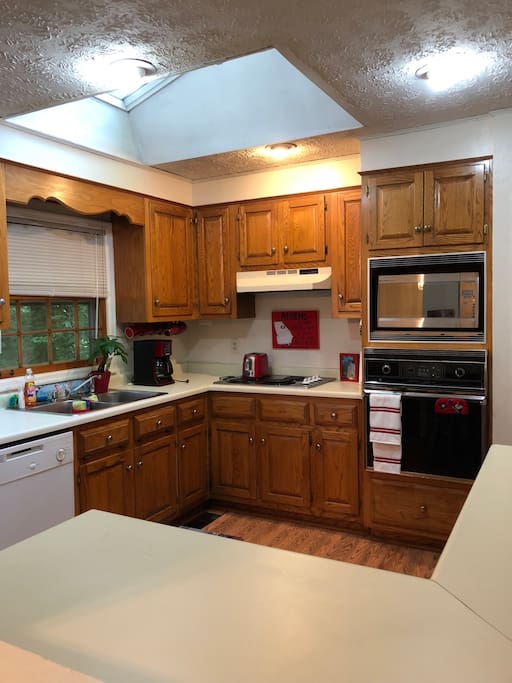 Great well stocked kitchen with a skylight and open windows connecting with the living room and dining room.