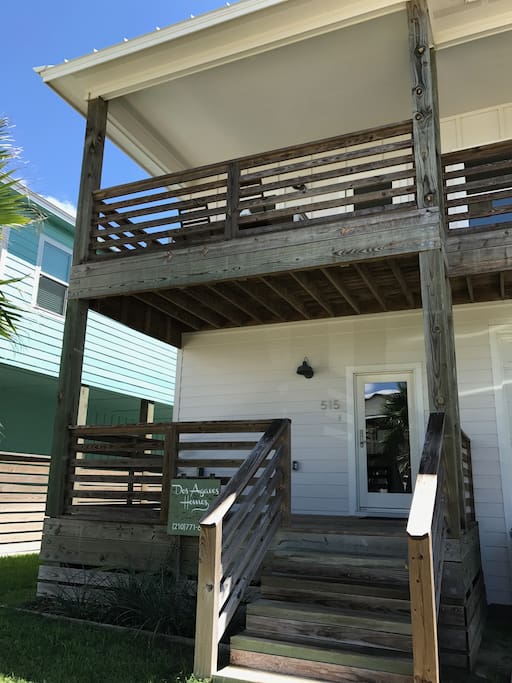 House facade with porch and upstairs balcony that overlooks birding sanctuary. Large outdoor dining table for al fresco dining!