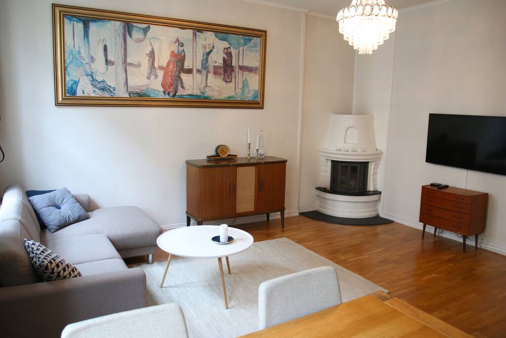 Livingroom with fireplace, chandelier, office desk and other cool details.