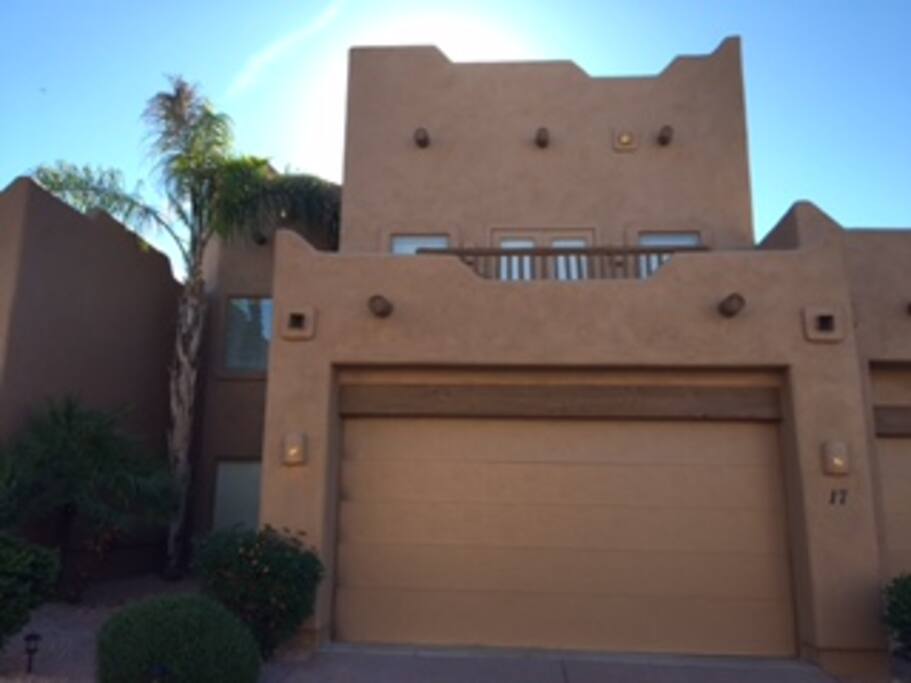 Front of townhome showing upper suite deck