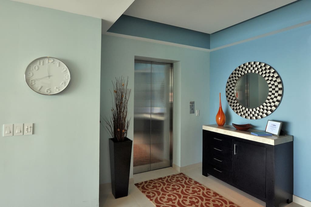 Security coded elevator opens directly into unit