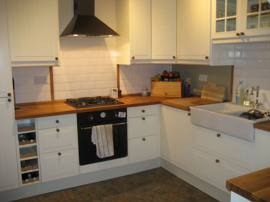 Newly fitted kitchen with plenty of natural light, dining area and view of back garden and huge tree!