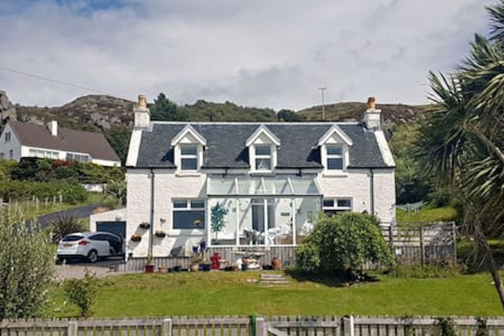 The house and conservatory. Every window is forward-facing and when you first see the views you will understand why. Almost 180 degrees of stunning Highland scenery.