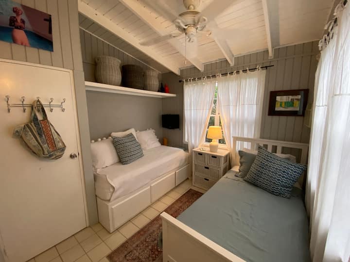 Cozy Bedroom on second floor sleeps two with two twin beds, AC and Ceiling fans.