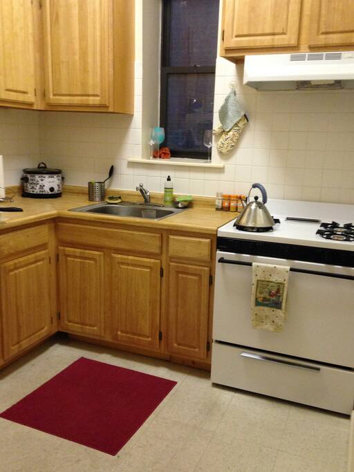 Full kitchen with gas stove and refrigerator.