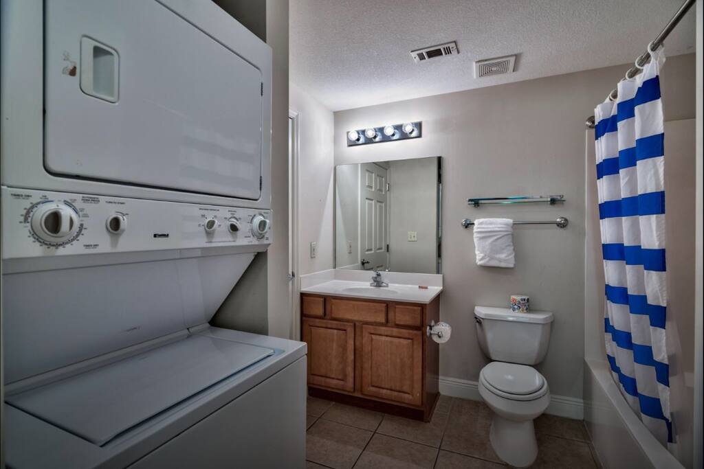 Full bathroom with stacked washer/dryer