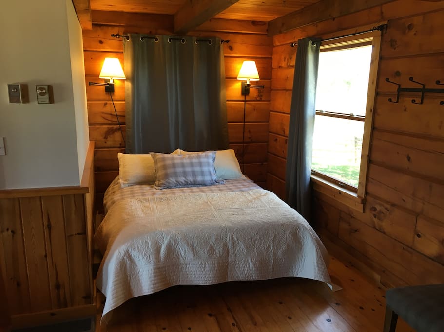 Queen bed in attached bunkie cabin, two additional twin beds in loft above this bed. Ensuite bathroom.