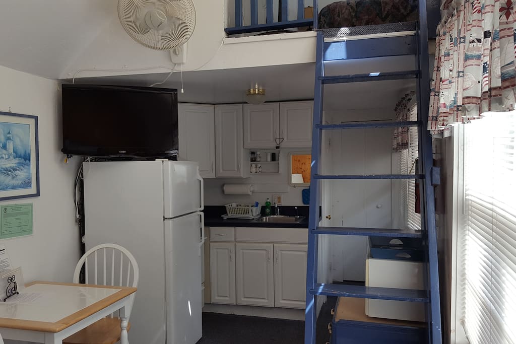 Kitchen area showing the ladder stairway to the loft bedroom.