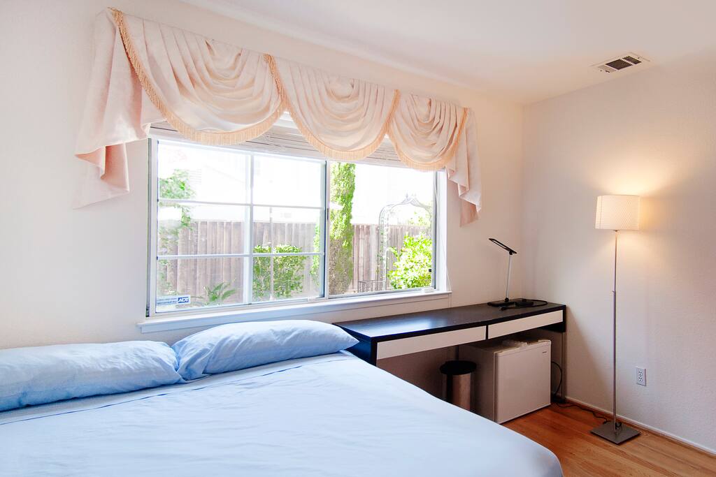 Full size spring bed, closet, desk, chair, and also a fridge in the room