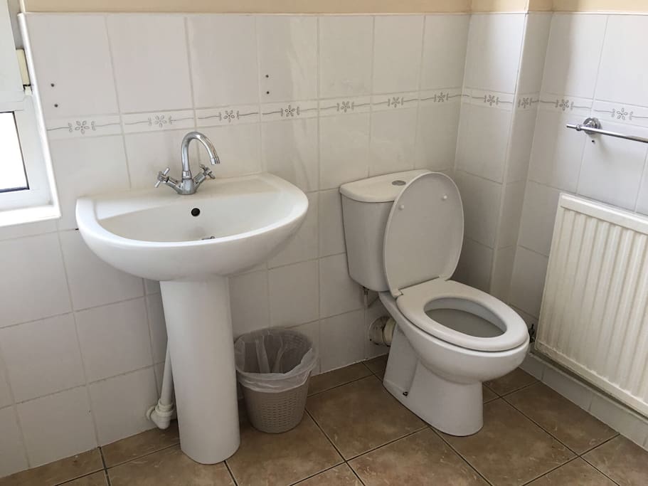 Toilet with bath to the left/ shower