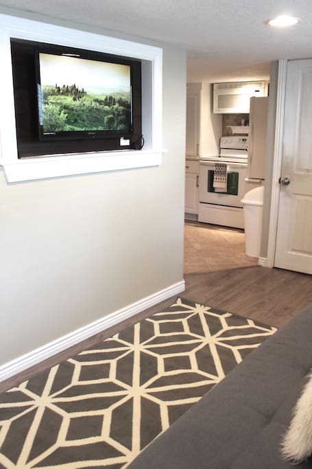 Mounted flatscreen TV with Amazon Firestick.