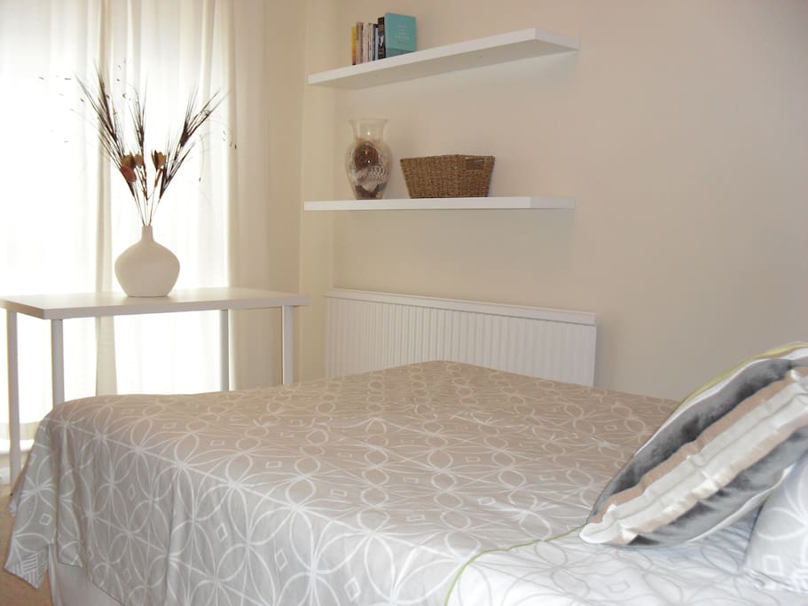 Double Room with garden view. Triple wardrobe, drawers, desk, shelving & TV