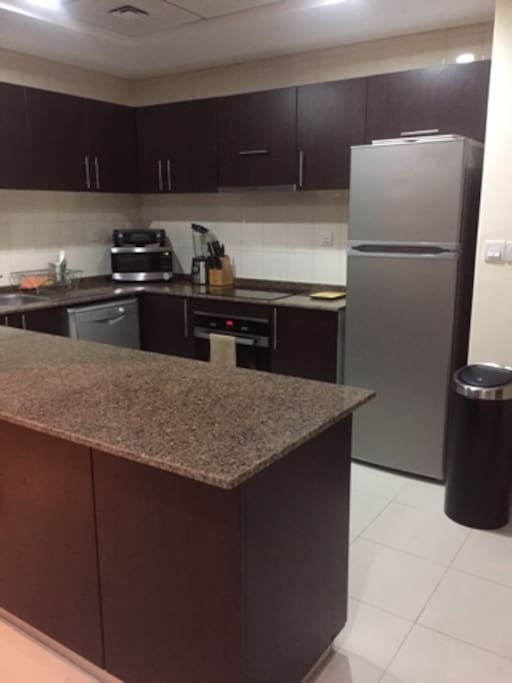 Kitchen Area with fridge, freezer, washing machine, dishwasher