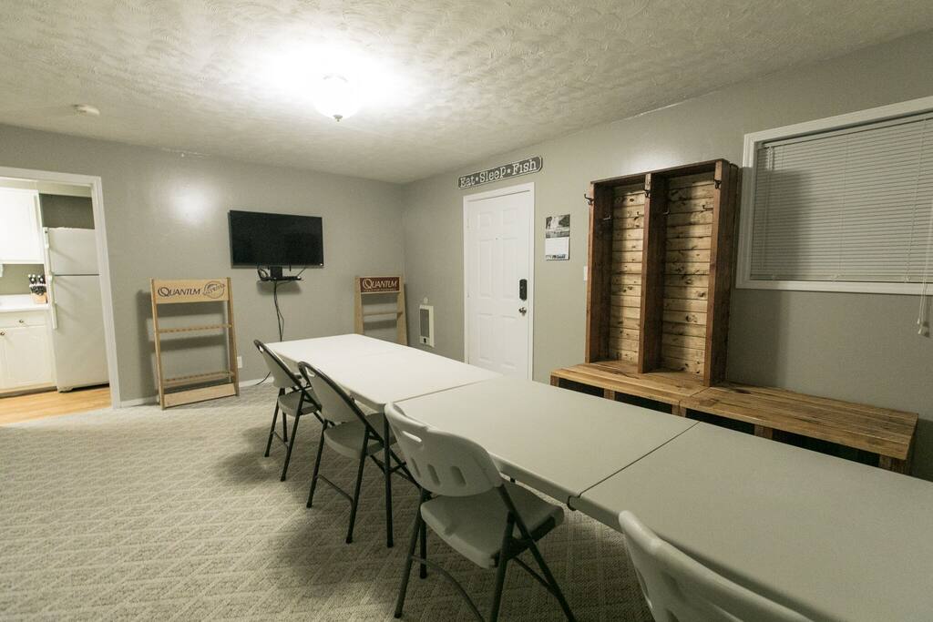 Tackle room, with TV, coat/shoe rack, fishing rod racks, and shelving