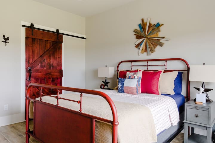The spacious bedroom has a farmhouse style queen size bed and large walk-in closet...