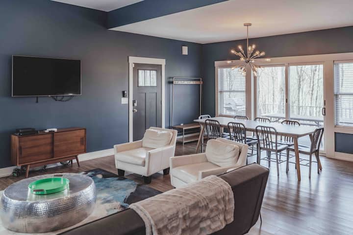 Main level dining and living room just off the entrance with quick access to the large outdoor dining area and hot tub!