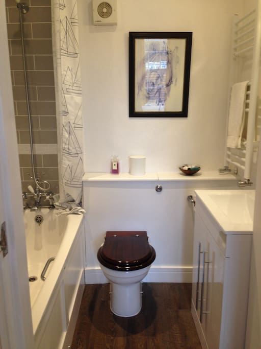 Bathroom with bath and shower over bath.