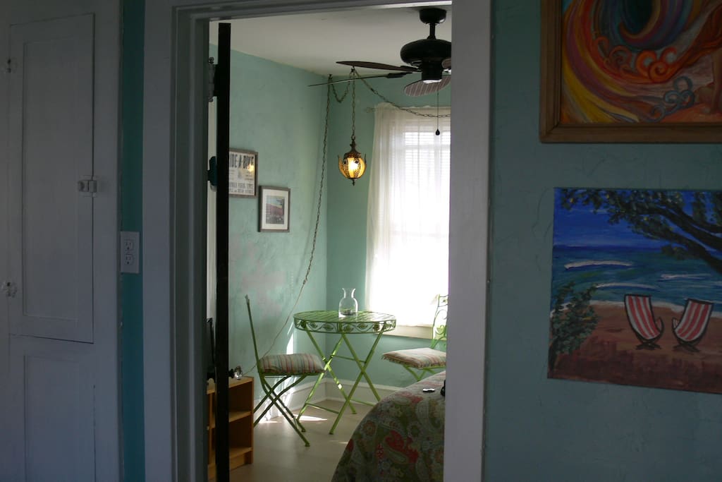 Corner bedroom has a café table and chairs just off the kitchen